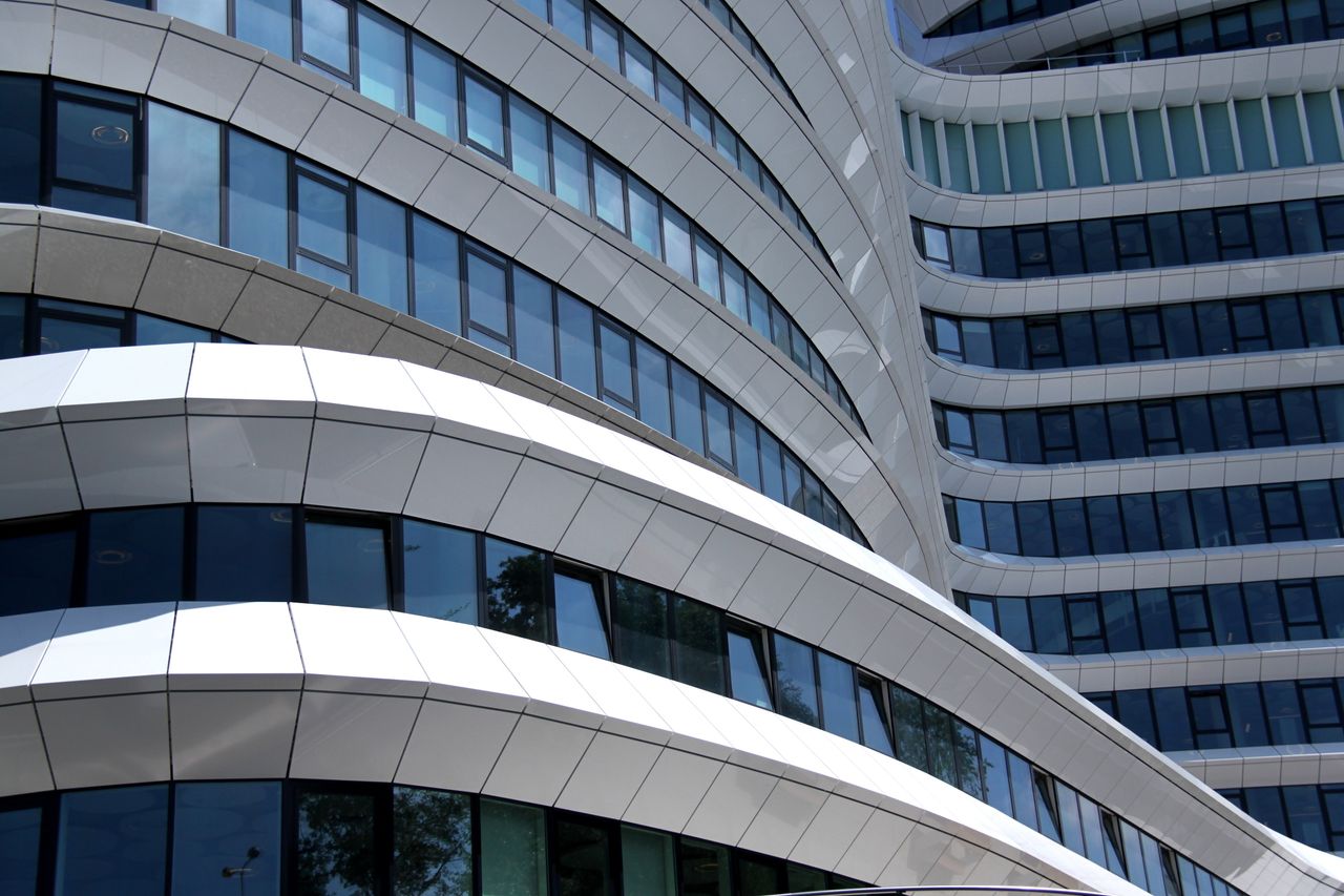 Crafting Captivating Headlines: Your awesome post title goes here Modern architecture featuring curved glass and steel facade with reflections.