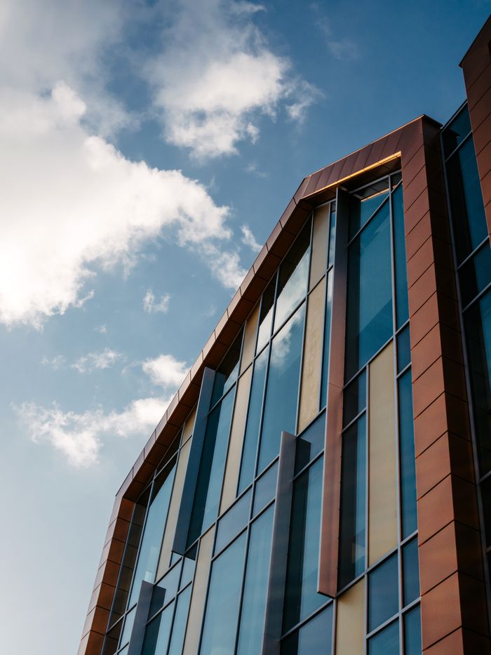 Mastering the First Impression: Your intriguing post title goes here Stylish architecture with glass and metal reflecting the blue sky.
